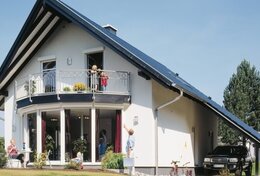 Fingerhut Einfamilienhaus weiß verputzt schwarzes Dach runder Erker runder Balkon zweifarbiger Dachüberstand